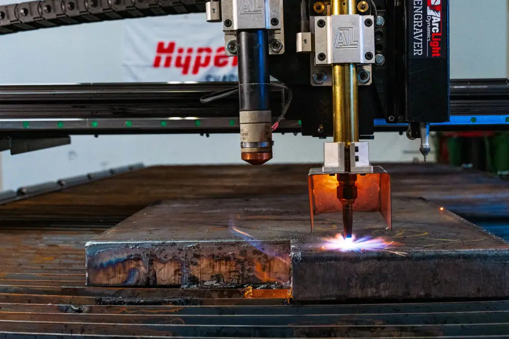 Arclight Arc Max 6x12 CNC plasma table mid-cut on a nested sheet