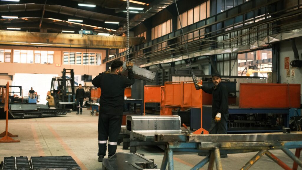 Workers operating machinery on a factory production floor